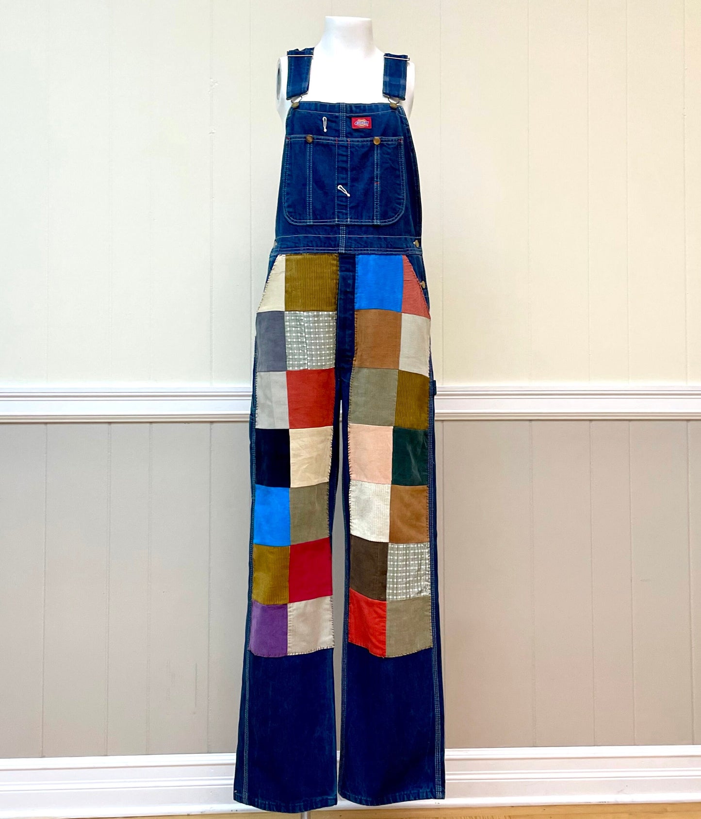 a mannequin wearing a patchwork denim jumpsuit