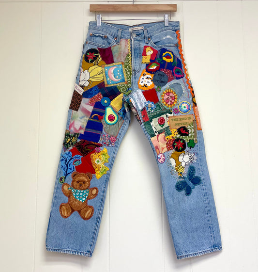 a pair of jeans with patches on them hanging on a wall