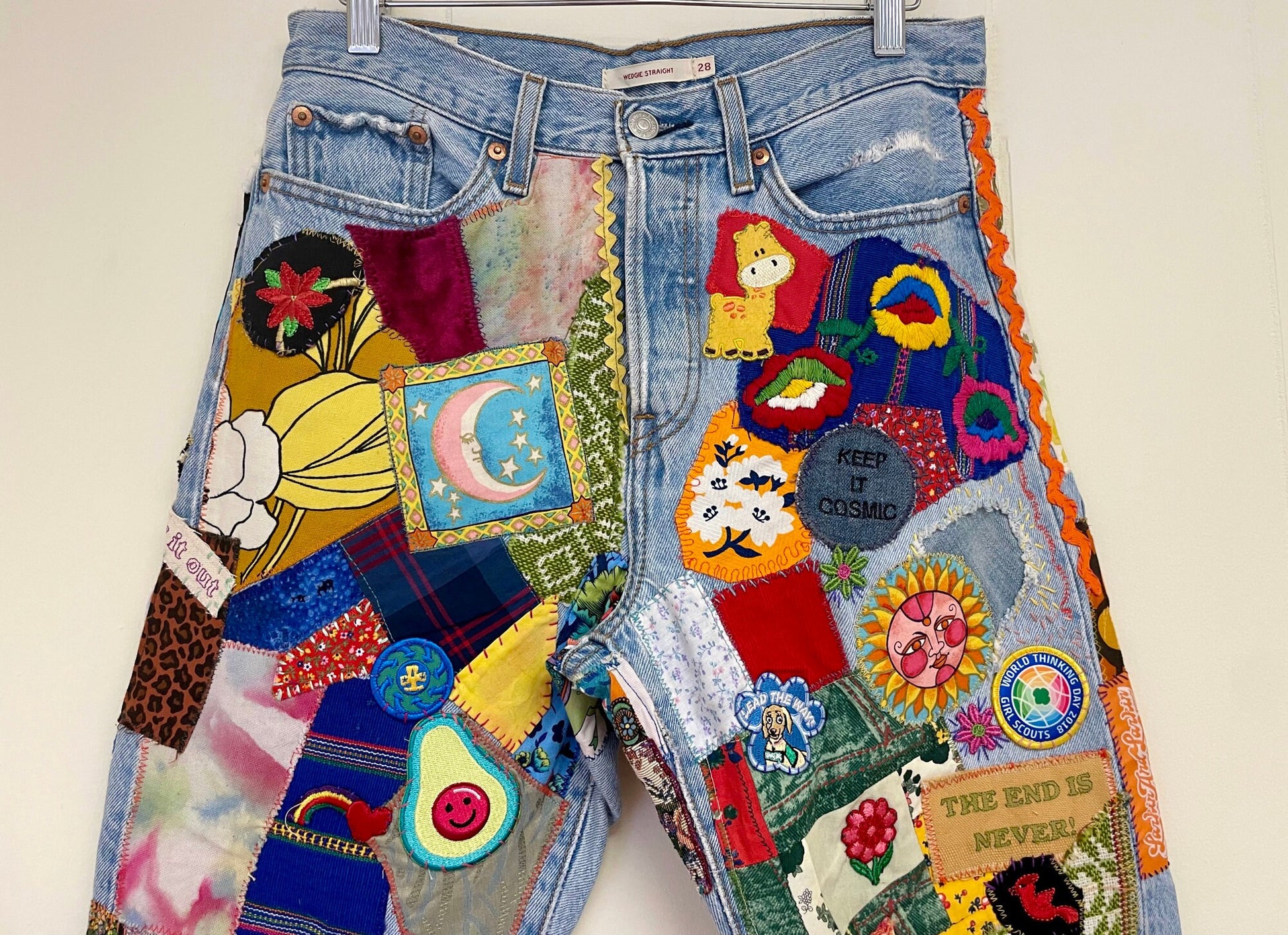 a pair of jean shorts with patches on them