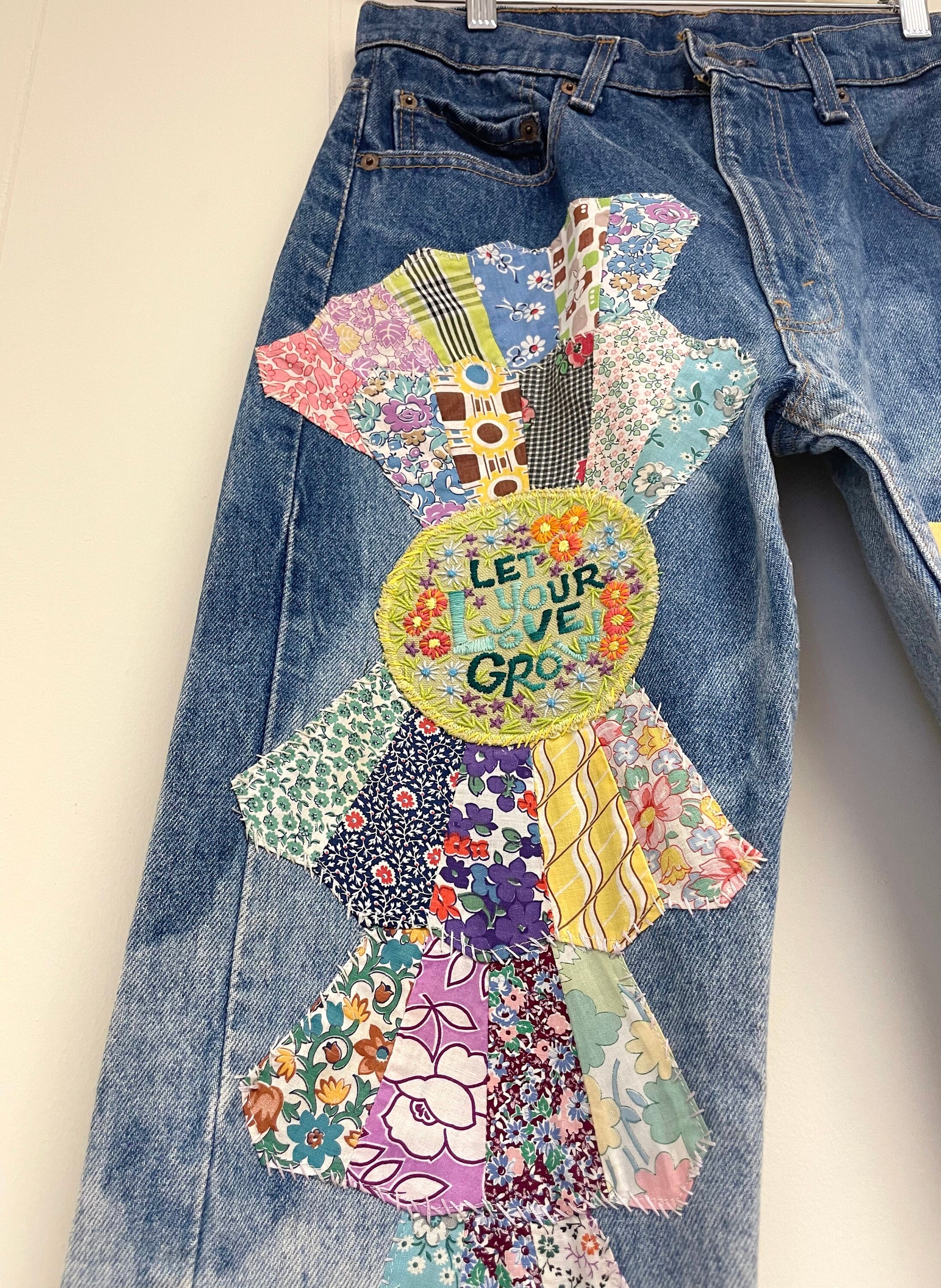 a pair of jeans with a patchwork design on them